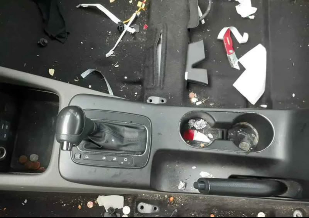 Dirty center console with trash and stains