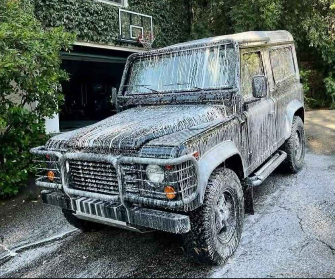 SUV covered in foam soap during wash